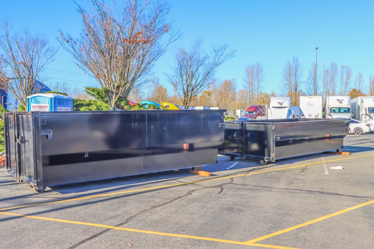 Professional dumpster rental service with roll-off container on residential driveway in Baker City